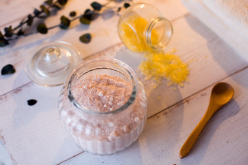 pink and yellow bath salt on white wooden table