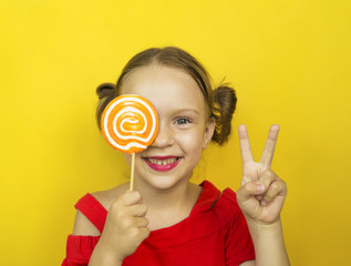 Beautiful young woman holds in hand candy