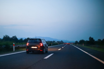 Fototapeta na wymiar Traffic on the highway at sunset