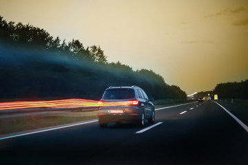 Fototapeta na wymiar Rear view of car driving on the highway