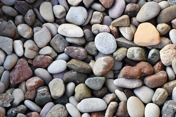 Beautiful colorful stones by the sea on the beach.