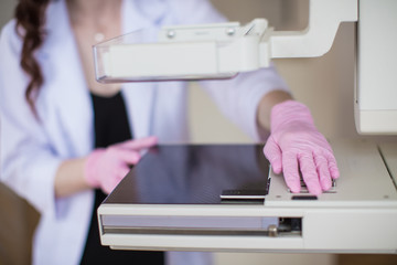 Close-up the apparatus of the ultrasound examination of the breast by which the breast specialist using indoors