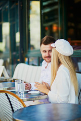 Happy couple in Parisian cafe