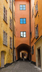 Fototapeta na wymiar Stockholm old narrow cobblestone street and passage in the historical city center gamla stan. Sweden.