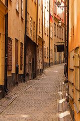 Fototapeta na wymiar Stockholm, perspective of old narrow cobblestone street. Sweden. 