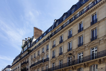Fototapeta na wymiar View of historical, traditional buildings showing Parisian / French architectural style. It is a sunny spring day in Paris. 2nd arrondissement