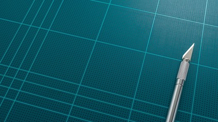 Grid cutting mat and sharp art knife, close up picture.