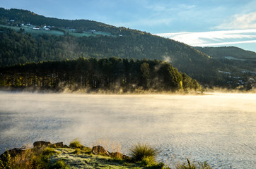 cold morning dust floating over norwegian landscape