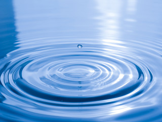 close up drop of water on blue background