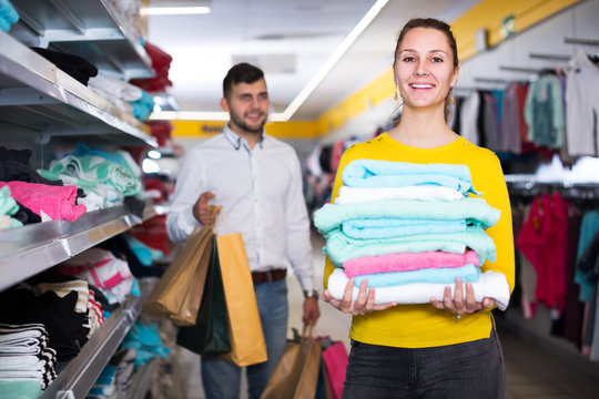 Woman holding towels in shop