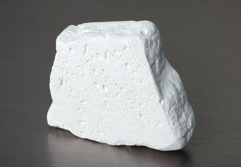 Specimen of mineral kaolinite (kaolin) on gray background