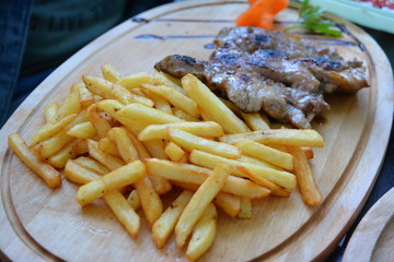 Plate with steak and french fries served in Romania
