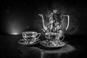Food background tea and coffee theme. Old vintage ceramic tea or coffee pot with cups jug and sugar...