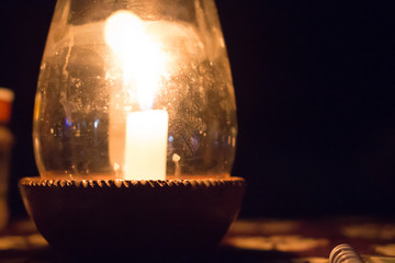 Candle in a Pot Under the Glass