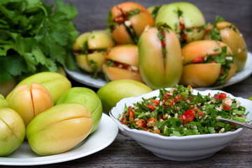 Green tomatoes stuffed with pepper and herbs in a plate.