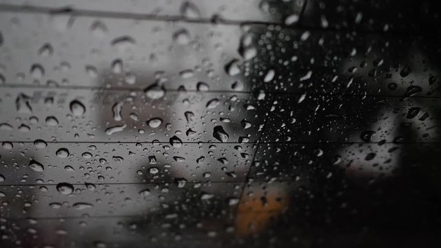 rain drops on glass window in the dark night