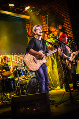 Band performs on stage in a nightclub