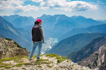 Obraz premium Hiker woman standing up achieving the top Dolomites Alps.