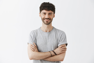 Waist-up shot of confident good-looking mature european male entrepreneur in t-shirt holding hands...