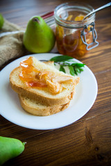 pieces of bread with sweet home-made fruit jam from pears and apples in a plate