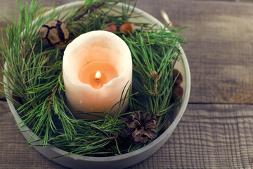 Christmas decor dish with fir branches and candles
