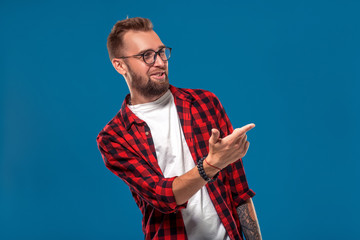 Emotional and people concept: young bearded man in checkered shirt. Hipster style.