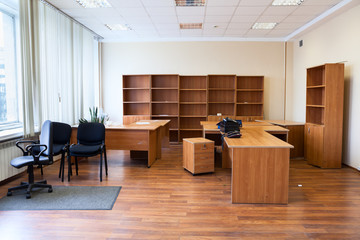 Remaining furniture as tables, chairs and cabinets in empty office after the tenant's eviction