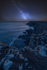 Vibrant Milky Way composite image over landscape of St Govan's Head on Pembrokeshire Coast in Wales