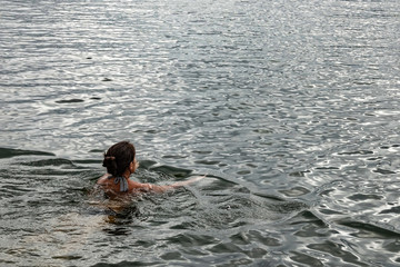 Woman swimming in the ocean. Copy space