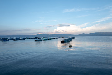 A boat on the beach at sunset