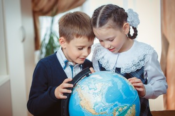 Two students with a globe