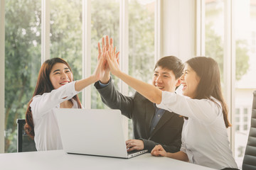 business people giving high five to celebrate success