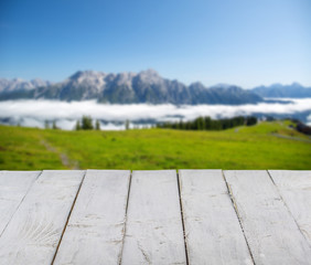Wooden emty board or table and austrian alps in the background