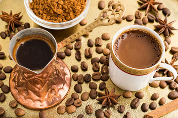 Vintage cup of turkish coffee and traditional bronze coffee pot served in bronze tray with roasted coffee beans, anise stars and cinnamon