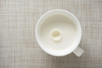 top view of glass milk with ripples drops