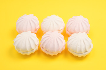 Rose marshmallows on yellow background. Zephyr.