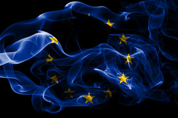 National flag of European Union made from colored smoke isolated on black background. Abstract silky wave background.