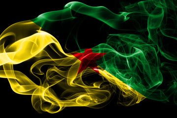 National flag of French Guiana made from colored smoke isolated on black background. Abstract silky wave background.