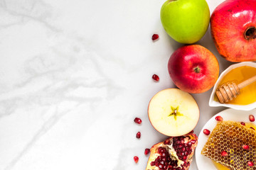 Honey, apple and pomegranate. traditional food for Jewish New Year Holiday, Rosh Hashanah on marble table. top view