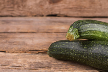 Close up zucchini and copyspace. Close up. Wooden table background.