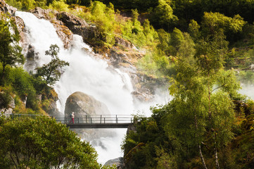 Fototapeta na wymiar Kleivafossen waterfall near Briksdal glacier in Norway. Summer landscape