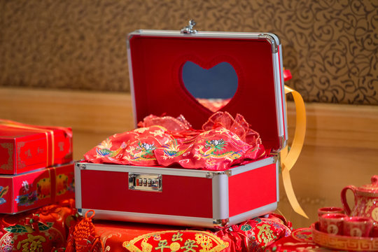 Chinese style safe furniture for wedding. Luxury red handle box on wood table. jewelry box.red box. image for background, wallpaper, copy space, illustration, objects and article.