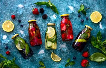Infused water in bottles, flat lay
