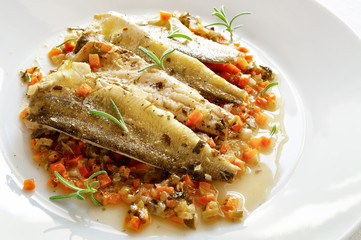 wine steamed marinated saffron cod on gravy stew with fried carrot, onion, leek, parsley and rosemary
