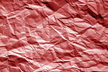Fototapeta premium Crumpled sheet of paper in red tone.