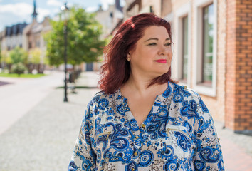 Fototapeta premium Pretty american middle age woman in vacation or at city. Size plus and xxl woman. Life of plump people in everyday life, faith in herself. Concept of life modern woman 