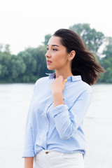 Portrait of a beautiful woman near the river.