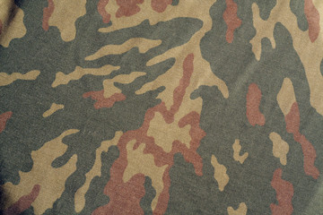 Old camouflage cloth with blur effect.