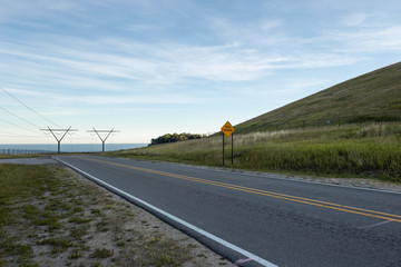 Power Electrical Lines From Hydro Electric Plant by Water and Road with Sign 