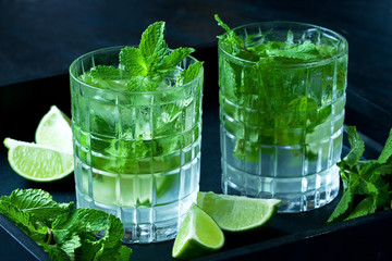 Mojito alcoholic cocktail  on  black wooden background.